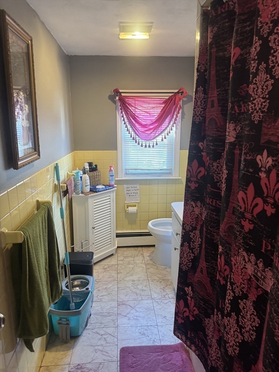 21 Cook, Unit 1 Chelsea, MA 02150 - Photo 3 of 32 a room with furniture and a potted plant