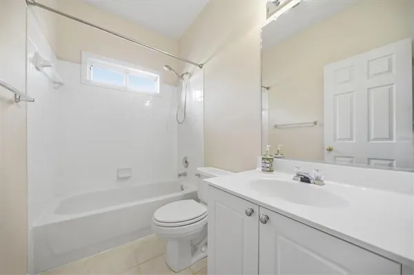 an aerial view of a house with a yard basket ball court and outdoor seating
