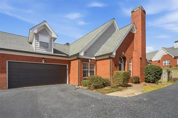 a living room with furniture a fireplace and a chandelier