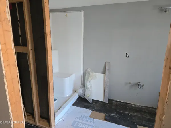 a view of a room with wooden floor and windows