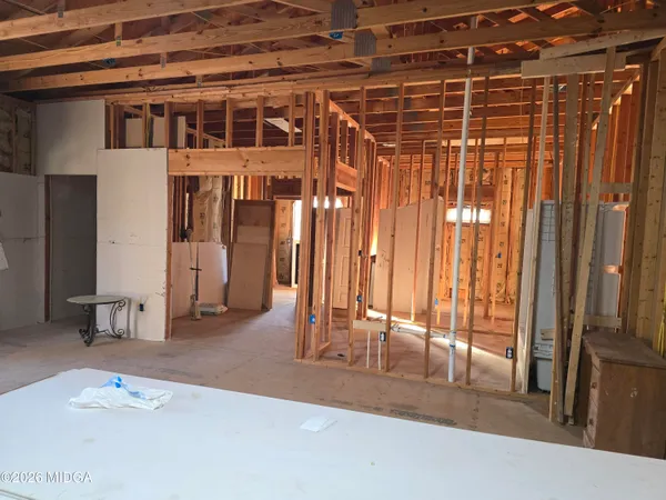 a view of a livingroom with wooden floor and a ceiling fan