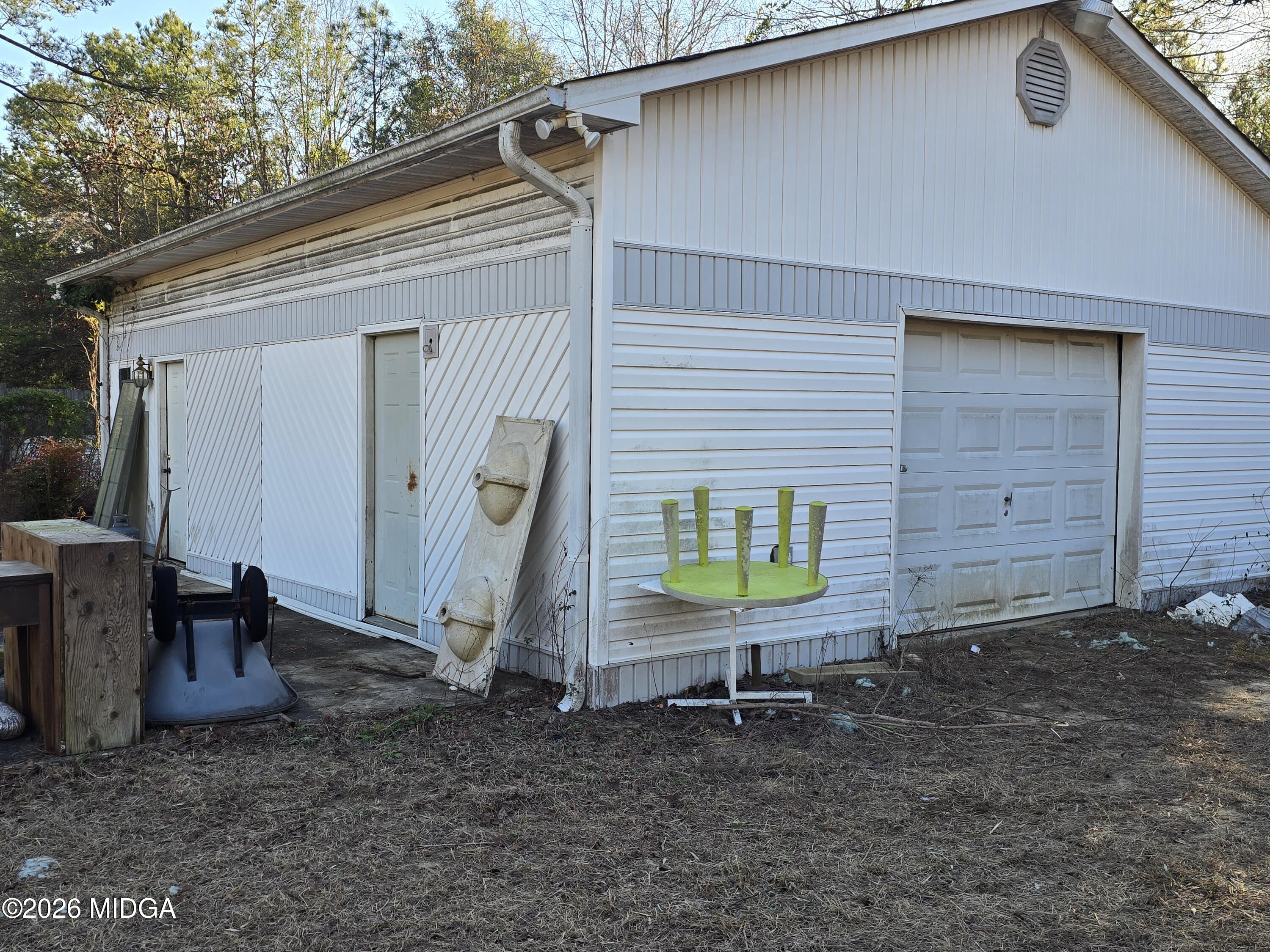 253 Pottery Road Lizella, GA 31052 - Photo 26 of 31 a backyard of a house with barbeque oven table and chairs