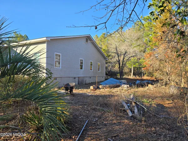 a backyard of a house with table and chairs