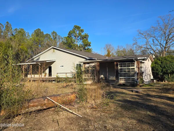 a view of a house with wooden fence