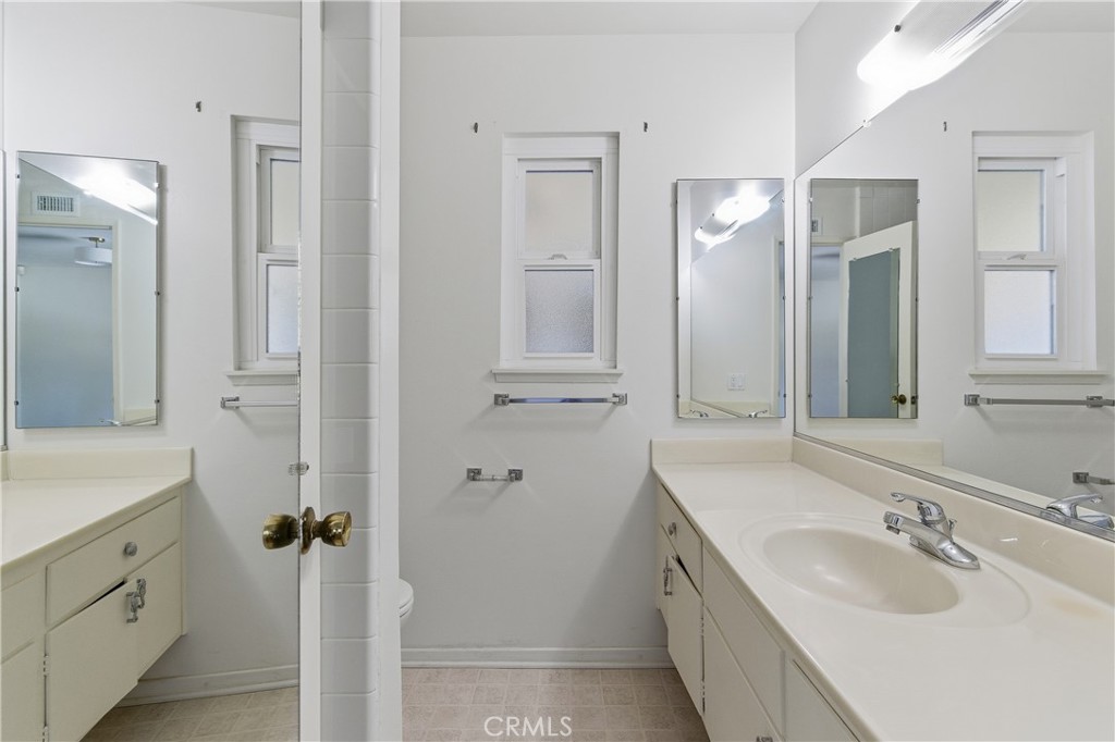 26136 Veva Way Calabasas, CA 91302 - Photo 15 of 22 a bathroom with a granite countertop double vanity sink mirror and