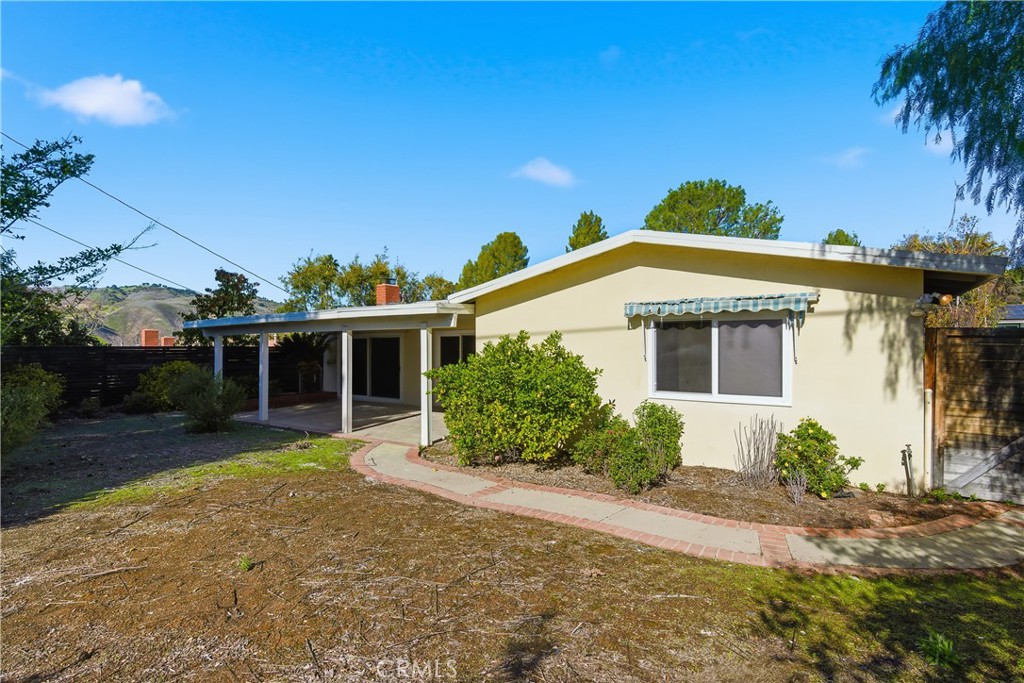26136 Veva Way Calabasas, CA 91302 - Photo 22 of 22 a front view of a house with a yard and potted plants