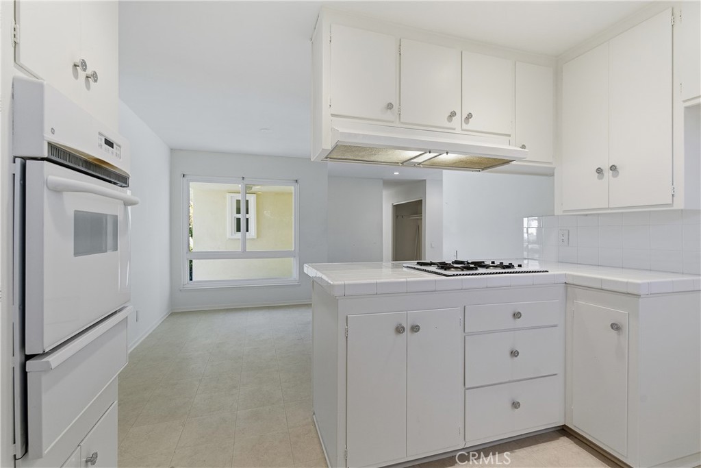 26136 Veva Way Calabasas, CA 91302 - Photo 7 of 22 a kitchen with granite countertop a stove a sink and a refrigerator