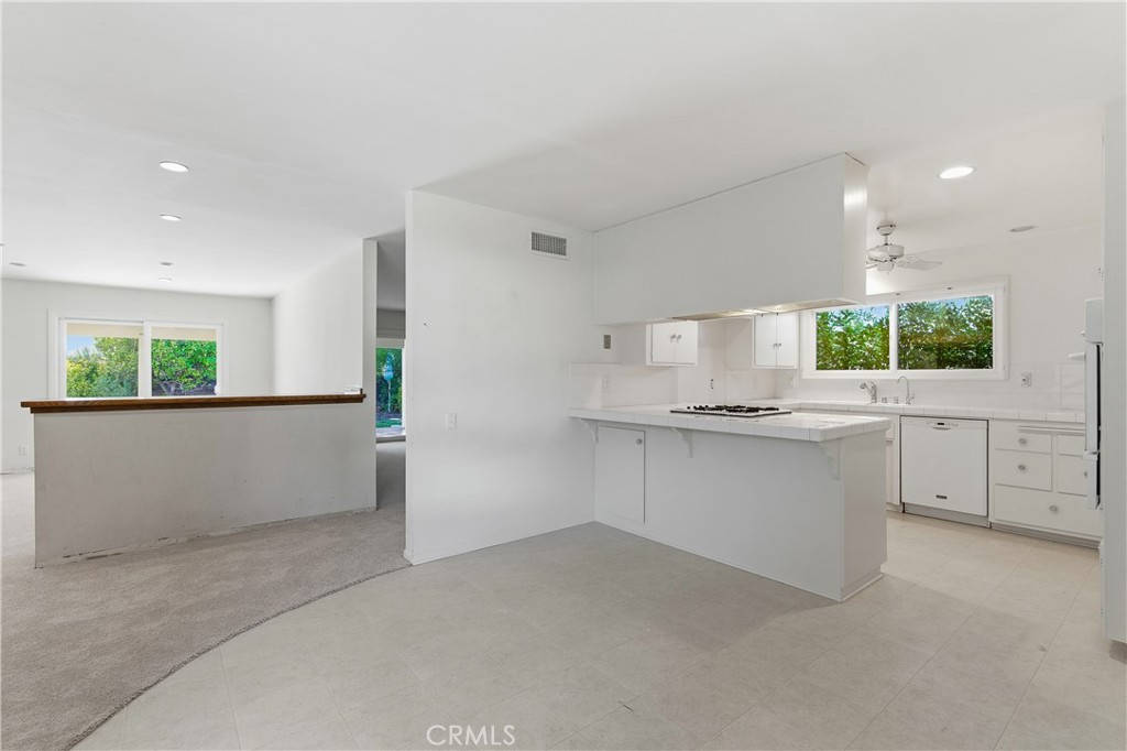 26136 Veva Way Calabasas, CA 91302 - Photo 8 of 22 a kitchen with white cabinets and window