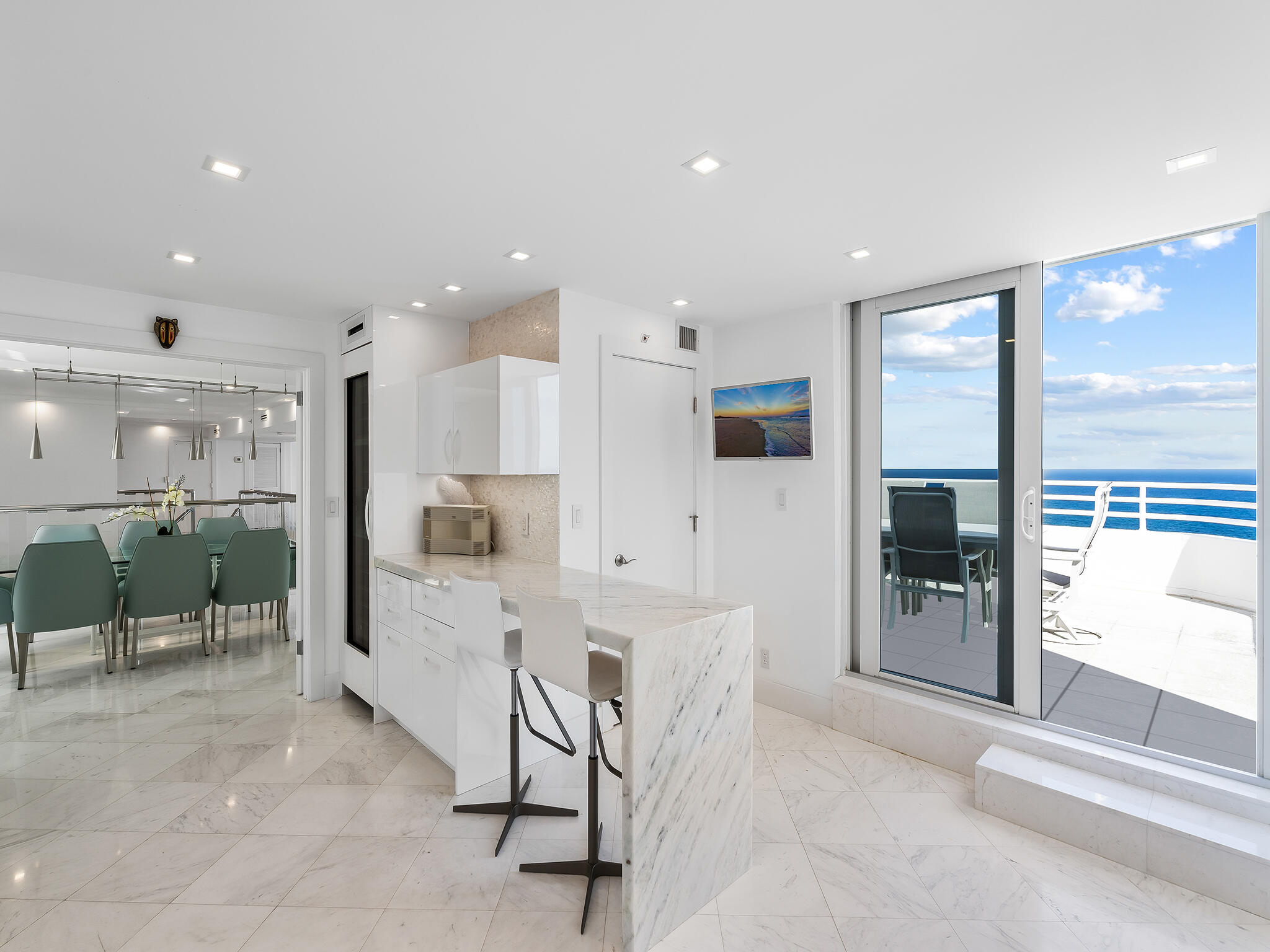 3407 South Ocean Boulevard, Unit PHB Highland Beach, FL 33487 - Photo 14 of 49 a large white kitchen with a large window and refrigerator