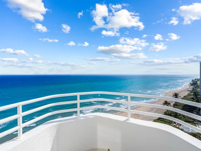 a large white bed in a white room