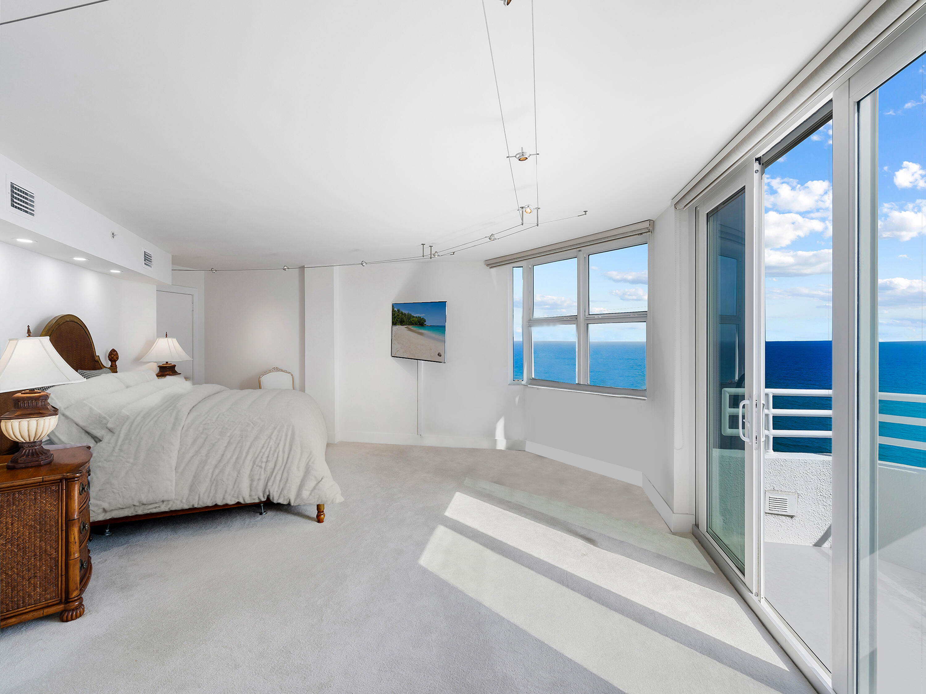 3407 South Ocean Boulevard, Unit PHB Highland Beach, FL 33487 - Photo 22 of 49 a spacious bedroom with a bed and a large window