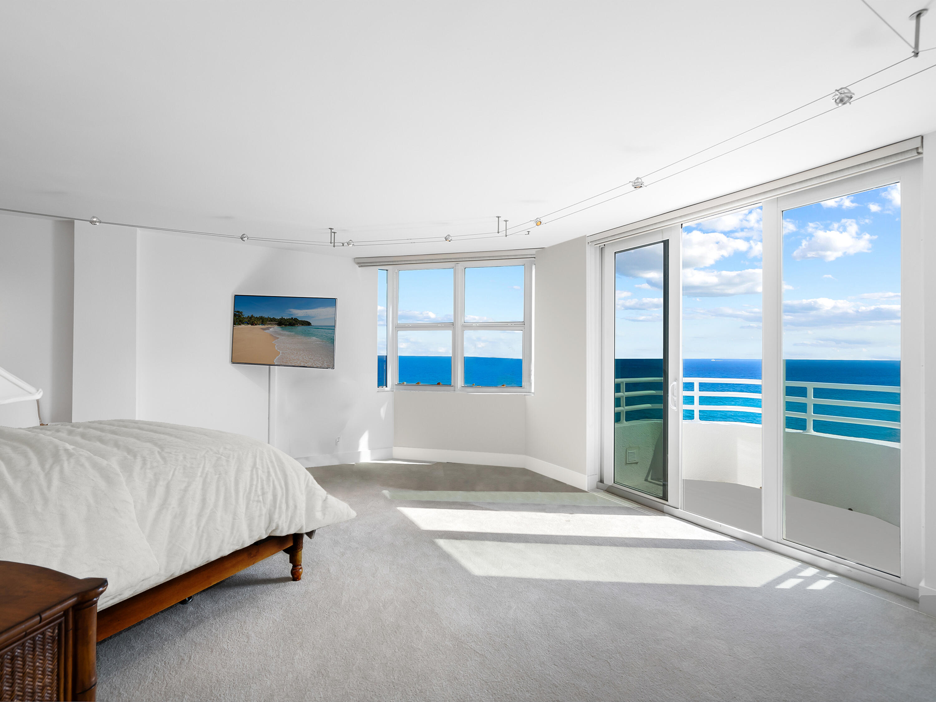 3407 South Ocean Boulevard, Unit PHB Highland Beach, FL 33487 - Photo 24 of 49 a spacious bedroom with a bed and a large window