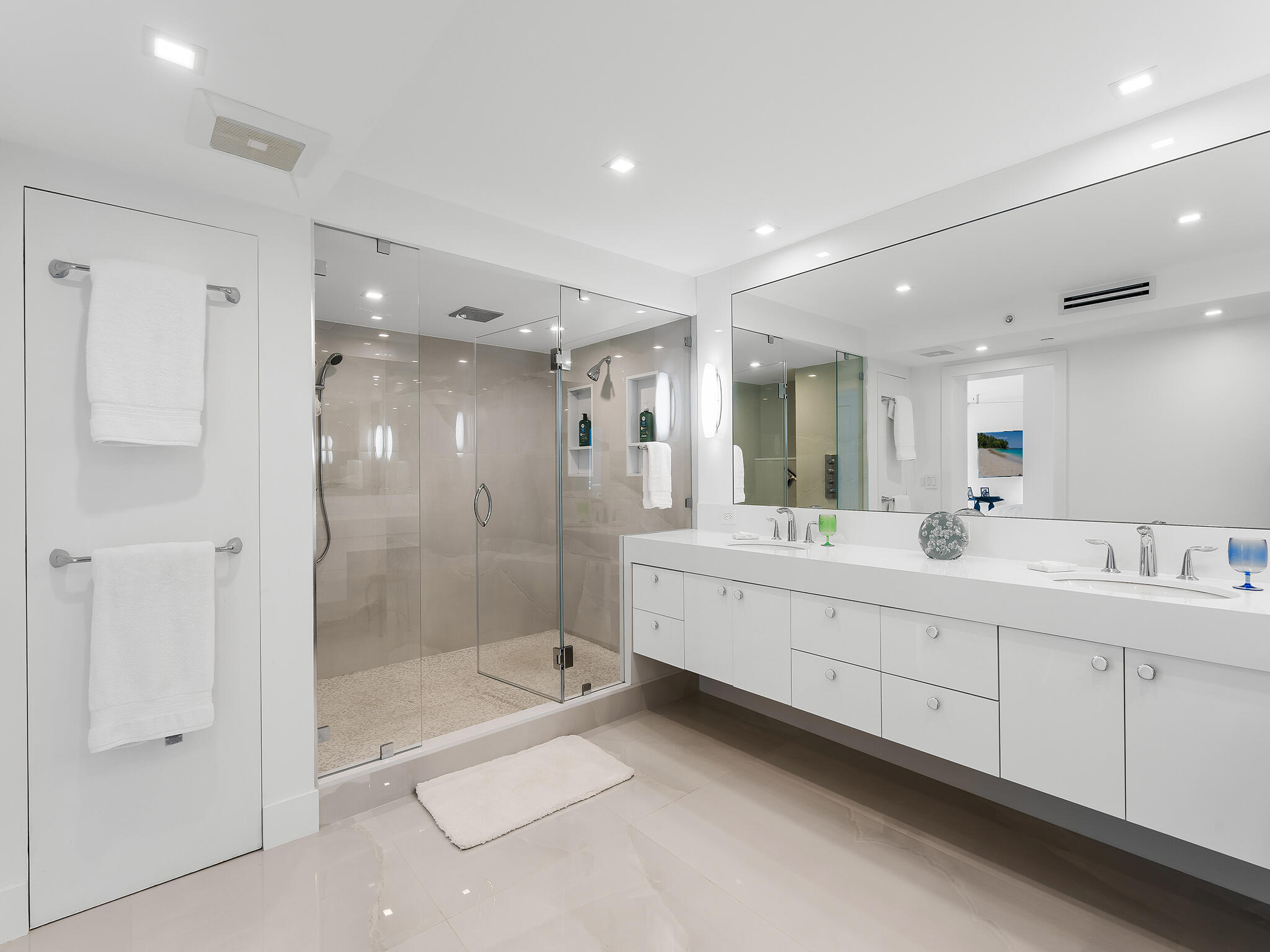 3407 South Ocean Boulevard, Unit PHB Highland Beach, FL 33487 - Photo 26 of 49 a bathroom with a double vanity sink mirror and shower