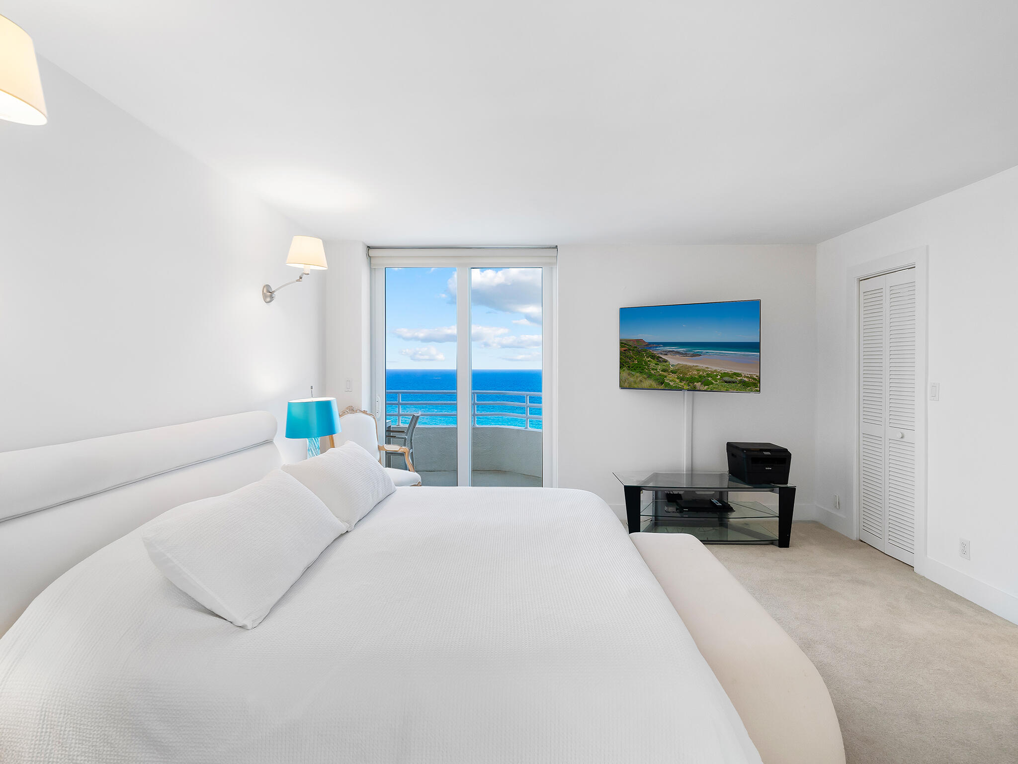 3407 South Ocean Boulevard, Unit PHB Highland Beach, FL 33487 - Photo 28 of 49 a bedroom with a bed a couch and a window