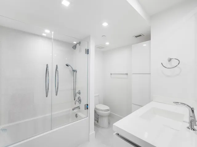 a bedroom with a large bed and a large window