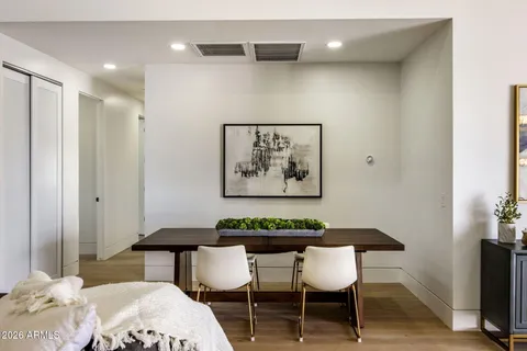 a kitchen with stainless steel appliances granite countertop a table chairs and a chandelier