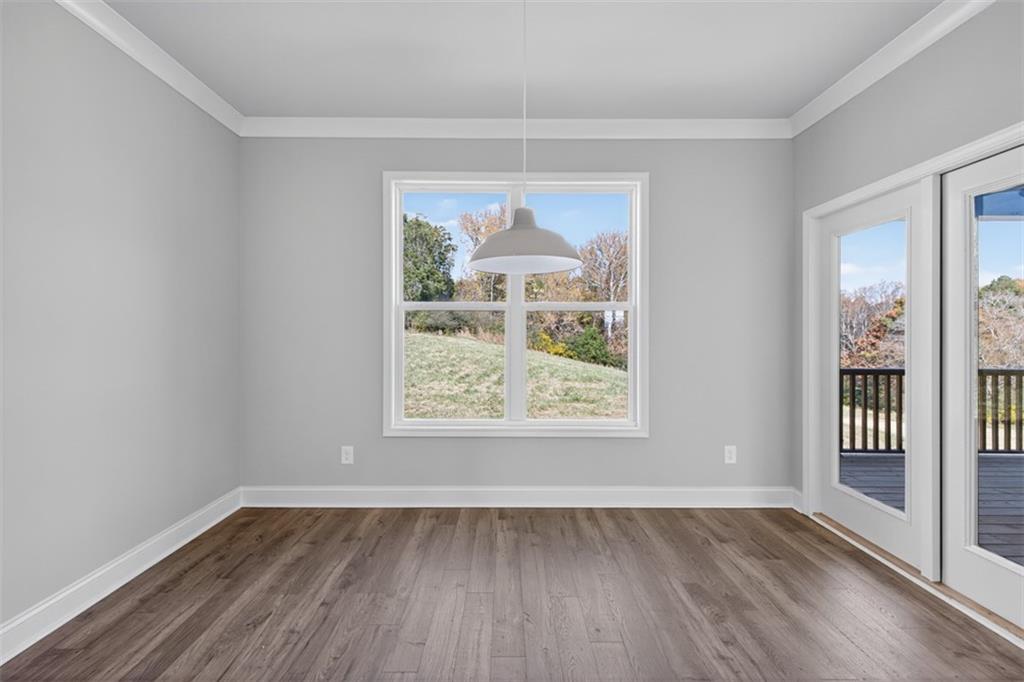 8845 Jot Em Down Road Gainesville, GA 30506 - Photo 26 of 87 an empty room with wooden floor and windows