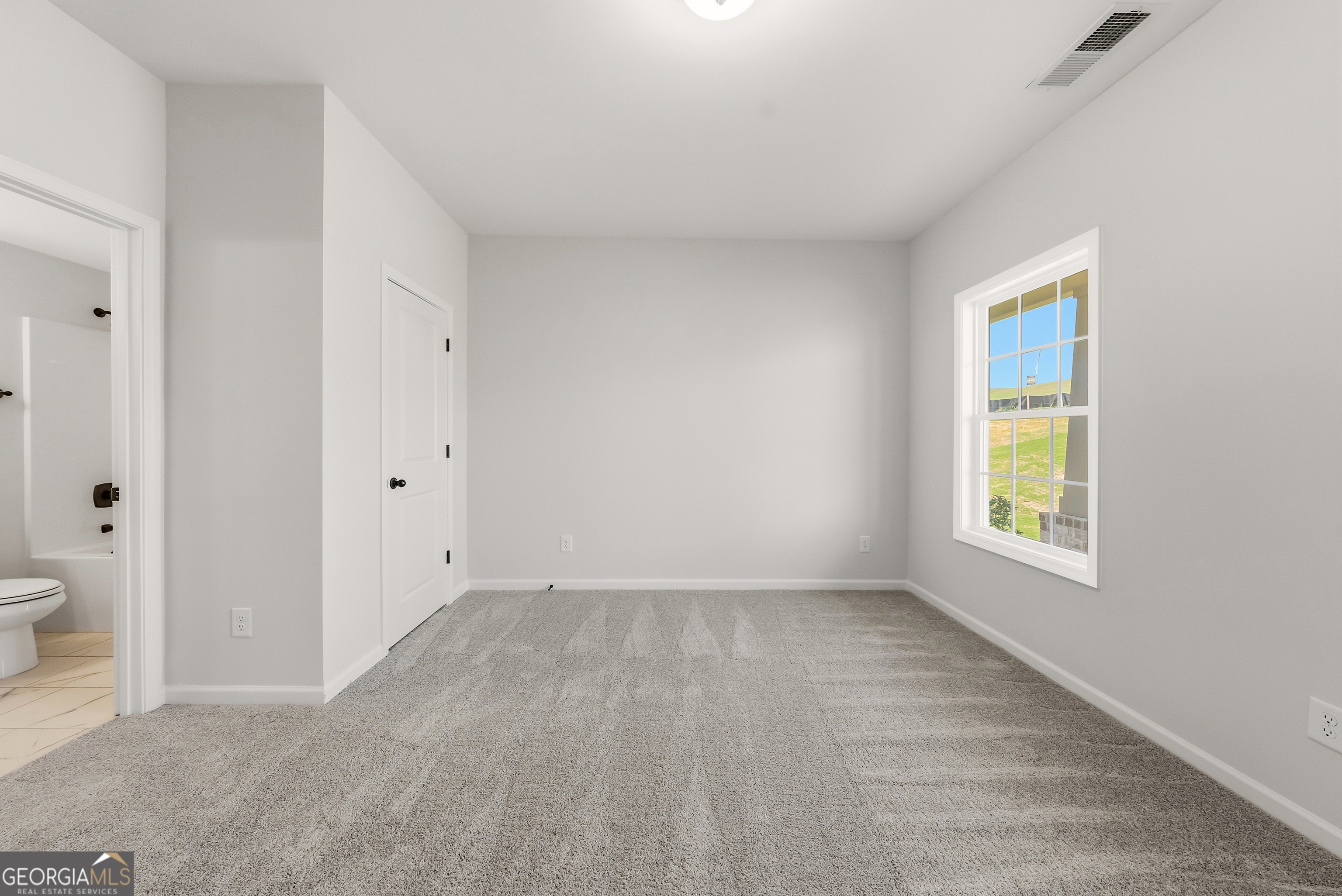 110 Hawkeye Trail, Unit 83 Fortson, GA 31808 - Photo 21 of 43 a view of an empty room with a window and a bathroom