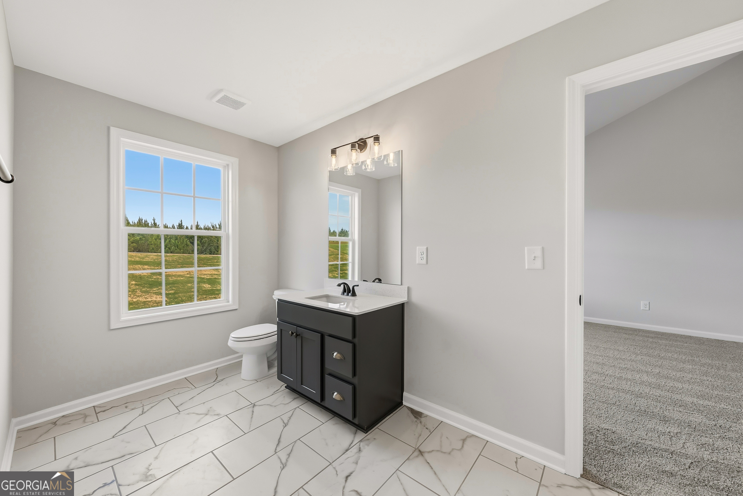 110 Hawkeye Trail, Unit 83 Fortson, GA 31808 - Photo 26 of 43 a spacious bathroom with a double vanity sink a mirror and a bathtub
