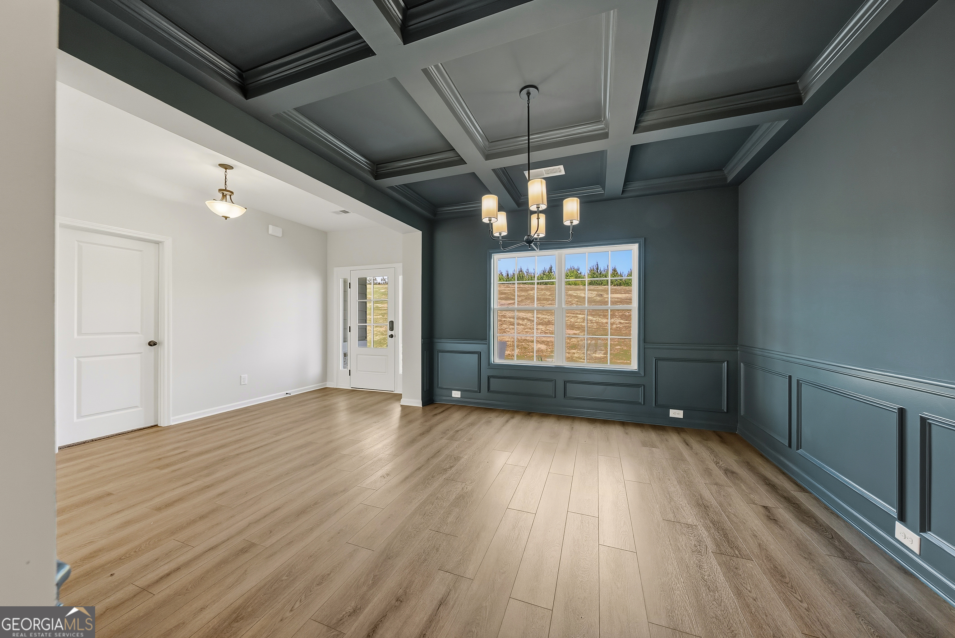 110 Hawkeye Trail, Unit 83 Fortson, GA 31808 - Photo 7 of 43 a view of an empty room with wooden floor and a window