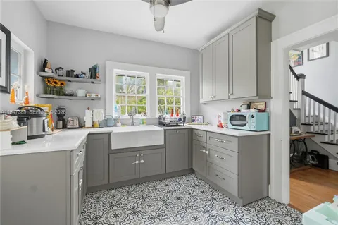 a kitchen with a sink cabinets and window