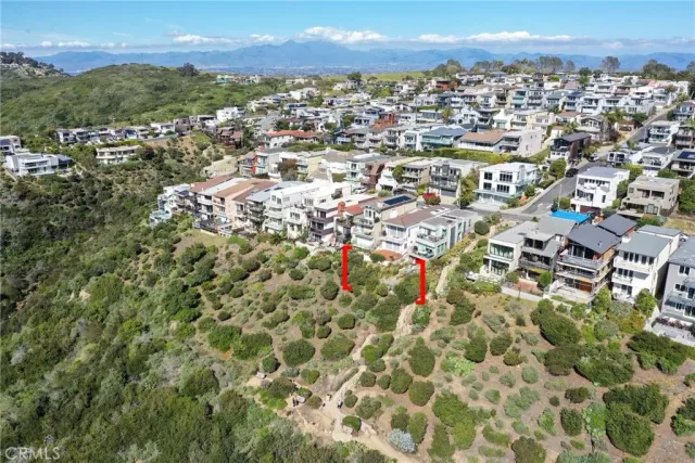 an aerial view of residential building with green space