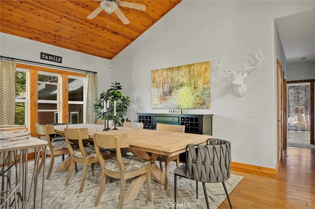 a dining room with furniture and wooden floor