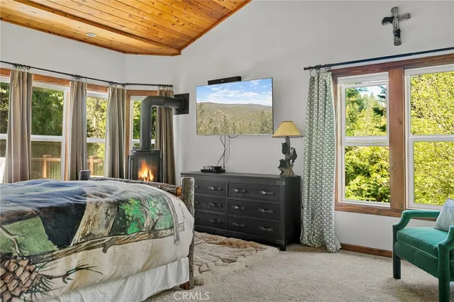 a spacious bedroom with a large bed and a chandelier