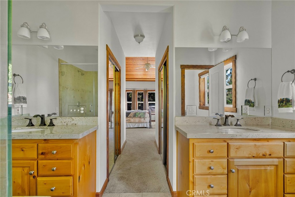 523 Dogwood Canyon Road Blue Jay, CA 92317 - Photo 17 of 33 a bathroom with a granite countertop sink and a mirror