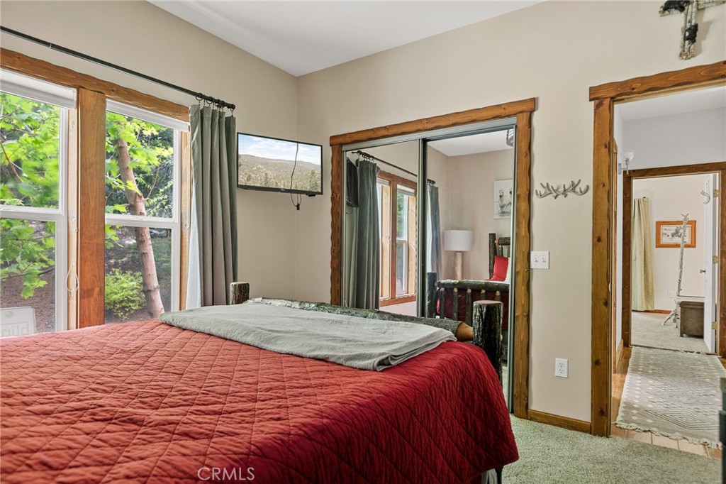 523 Dogwood Canyon Road Blue Jay, CA 92317 - Photo 19 of 33 a bedroom with a large bed and a large window