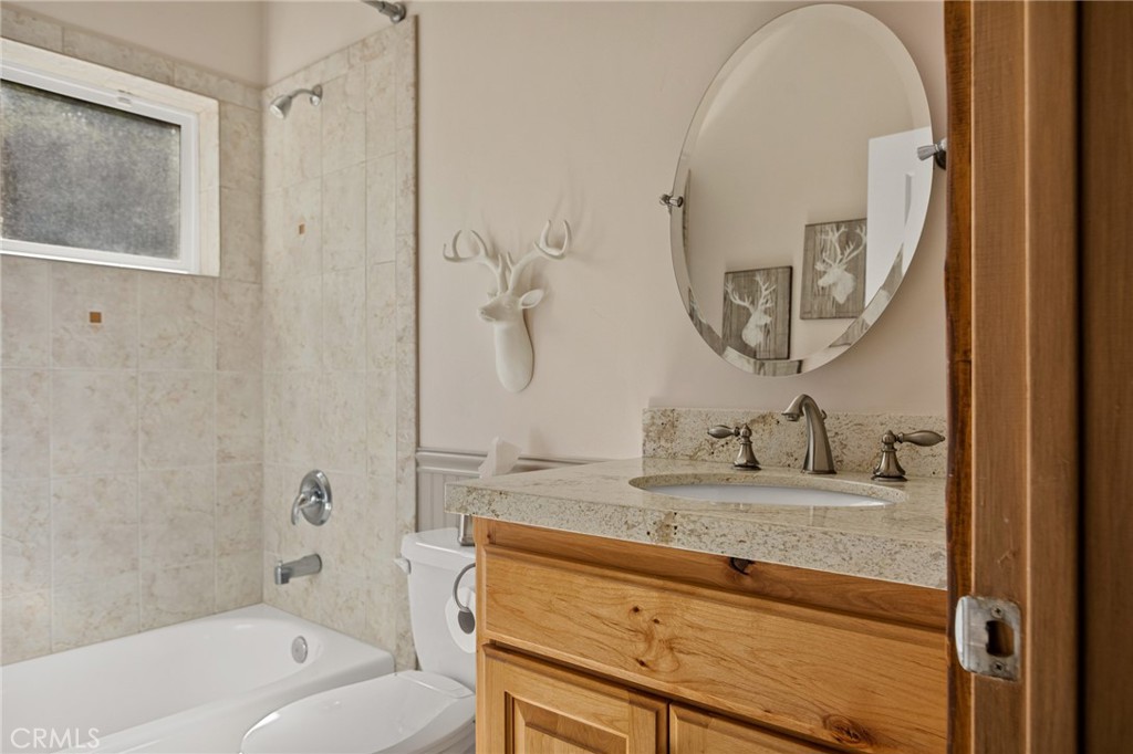 523 Dogwood Canyon Road Blue Jay, CA 92317 - Photo 20 of 33 a bathroom with a granite countertop sink a mirror and a bathtub