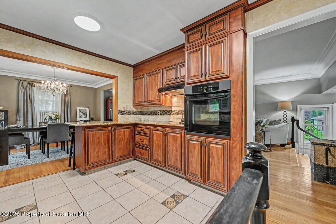 121 T Rt 351 Moscow, PA 18444 - Photo 31 of 79 a kitchen with stainless steel appliances granite countertop a refrigerator a stove and a sink with wooden cabinets