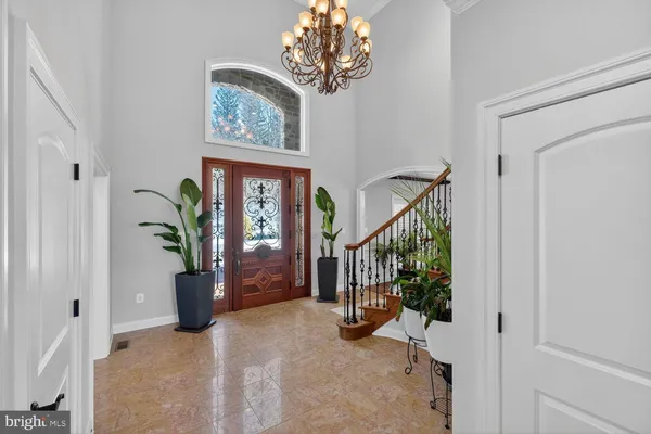 a view of a room with wooden floor and chandelier