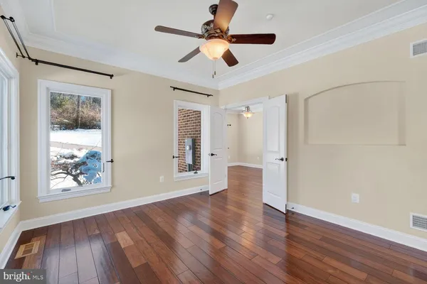 a kitchen with stainless steel appliances granite countertop a stove a sink and white cabinets