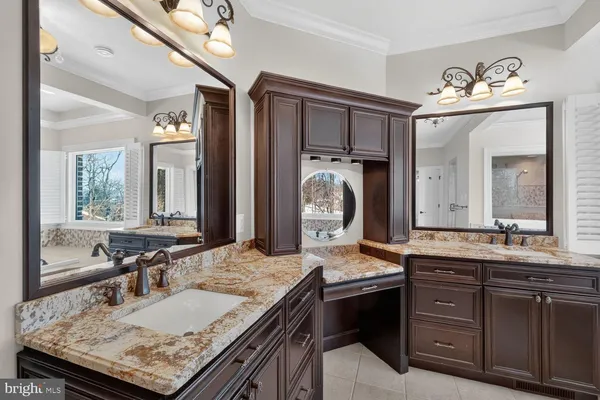 a view of a bathroom with a sink and a mirror