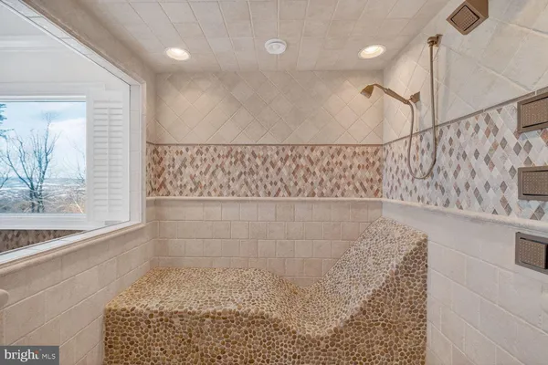 a bathroom with a bath tub with a shower