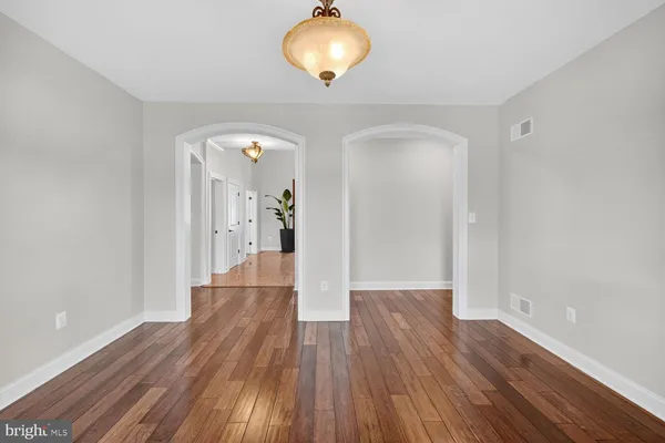 a view of entryway and hall with wooden floor