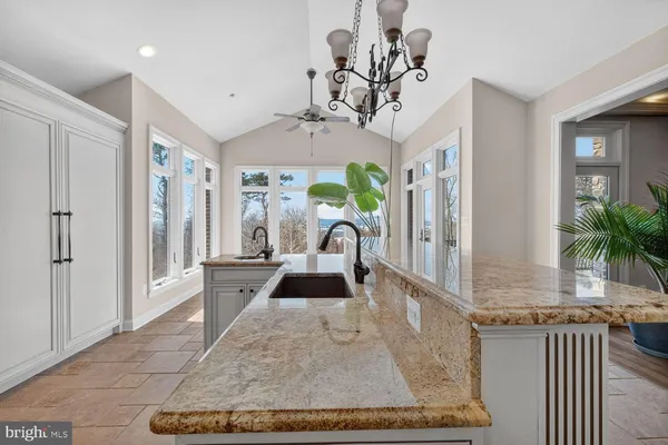a bathroom with a granite countertop toilet a sink a mirror and shower