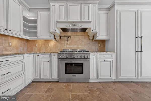 a view of a house with a wooden fence