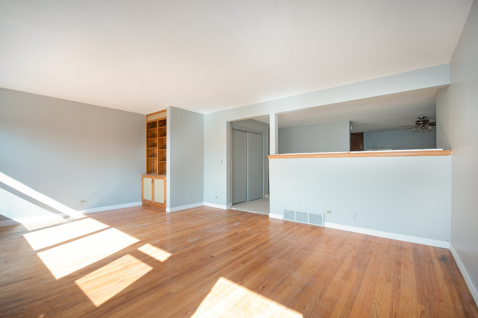 10448 West Cermak Road, Unit 1F Westchester, IL 60154 - Photo 2 of 9 a view of a big room with wooden floor and windows