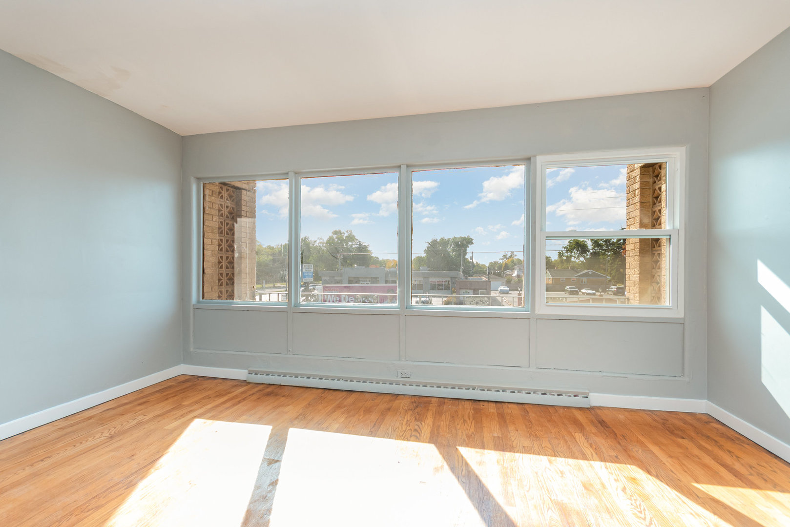 10448 West Cermak Road, Unit 1F Westchester, IL 60154 - Photo 6 of 9 a view of empty room with wooden floor and fan