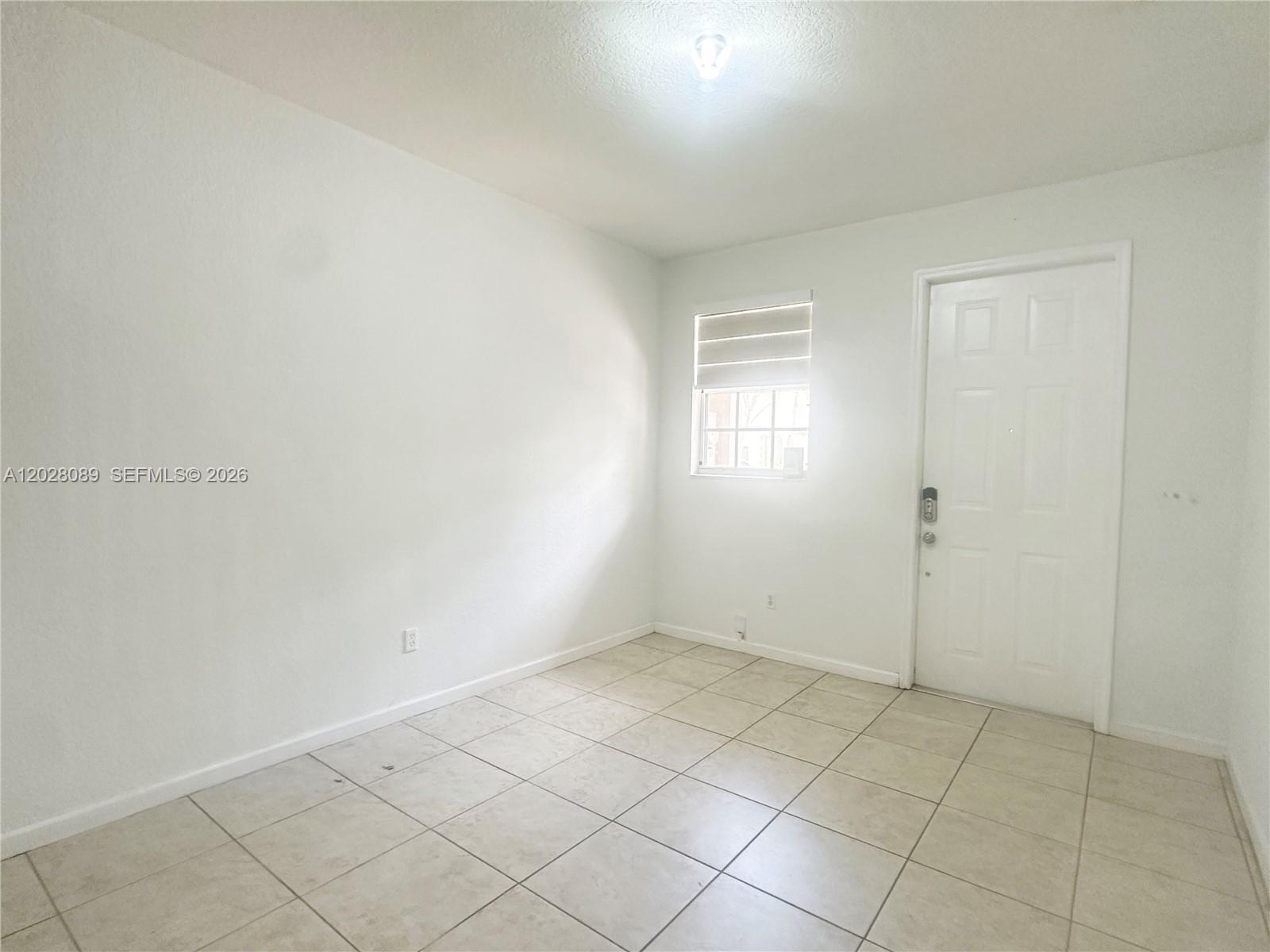 662 Northeast 21st Terrace Homestead, FL 33033 - Photo 3 of 34 an empty room with windows