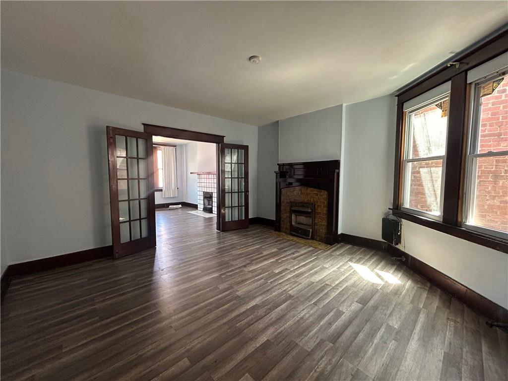 815 Broadway Avenue McKees Rocks, PA 15136 - Photo 3 of 7 an empty room with wooden floor and windows