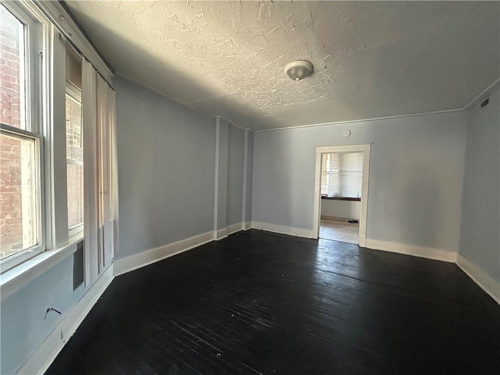 815 Broadway Avenue McKees Rocks, PA 15136 - Photo 5 of 7 a view of an empty room with wooden floor and a window