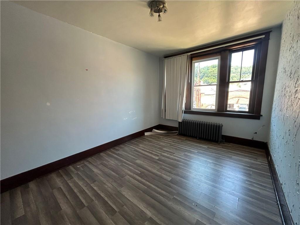 815 Broadway Avenue McKees Rocks, PA 15136 - Photo 6 of 7 an empty room with wooden floor and windows