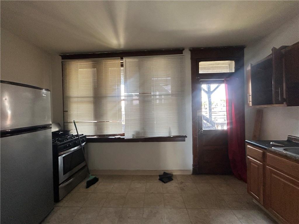 815 Broadway Avenue McKees Rocks, PA 15136 - Photo 7 of 7 a kitchen with granite countertop a refrigerator and a sink