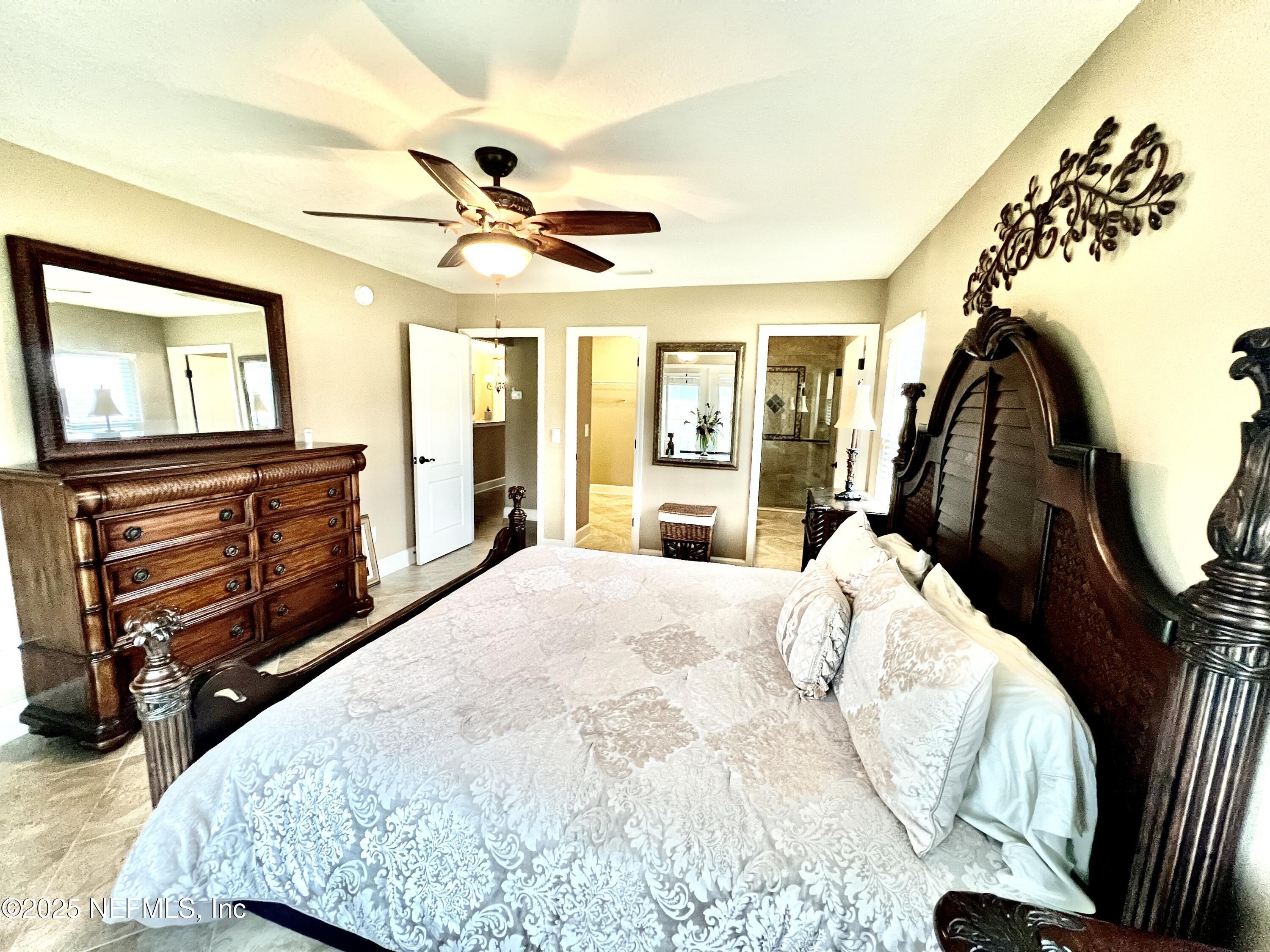 1024 Ardmore Street St. Augustine, FL 32092 - Photo 16 of 25 a bedroom with a bed and a flat tv screen on dresser