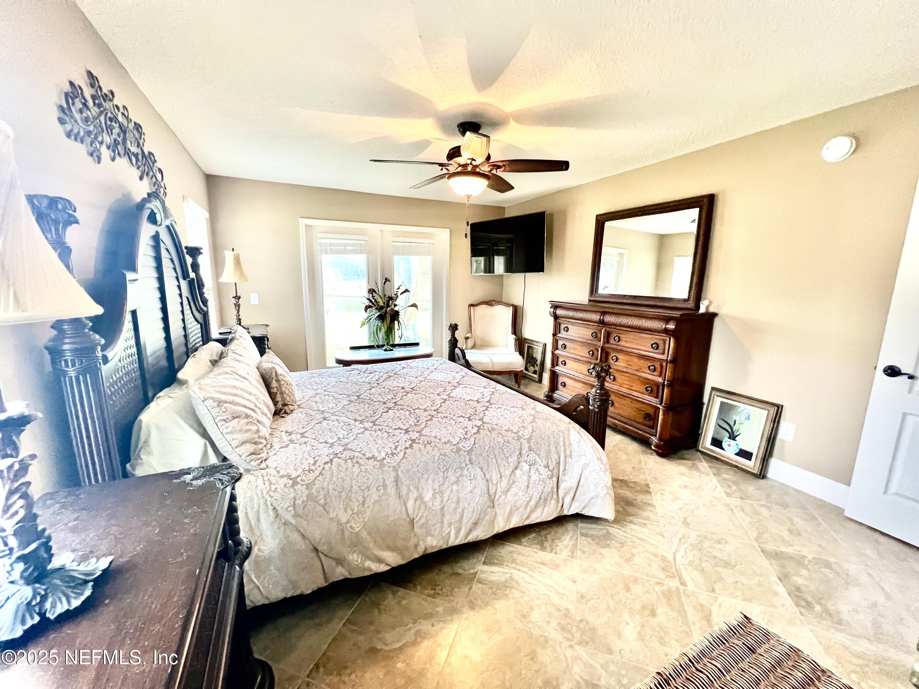 1024 Ardmore Street St. Augustine, FL 32092 - Photo 17 of 25 a bedroom with a bed wooden floor and ceiling fan