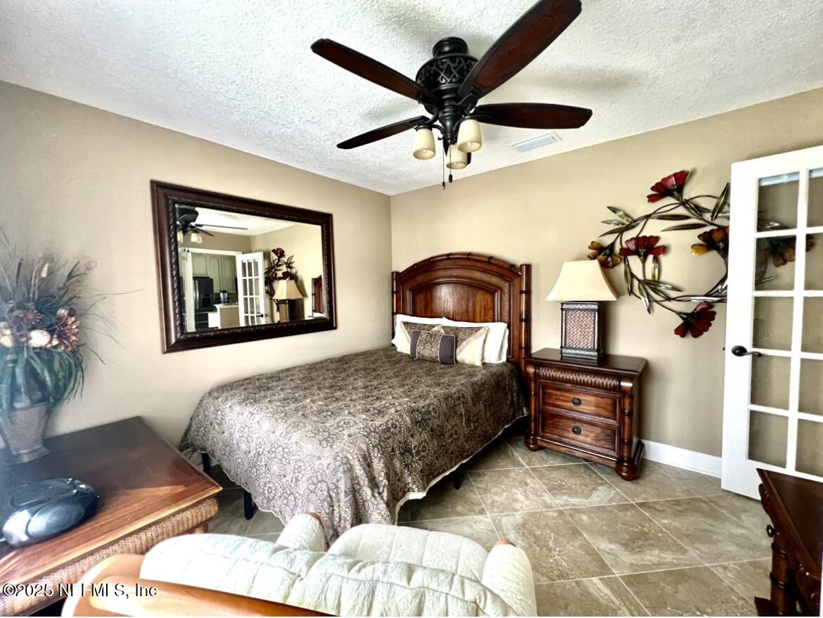 1024 Ardmore Street St. Augustine, FL 32092 - Photo 20 of 25 a bedroom with furniture and a chandelier