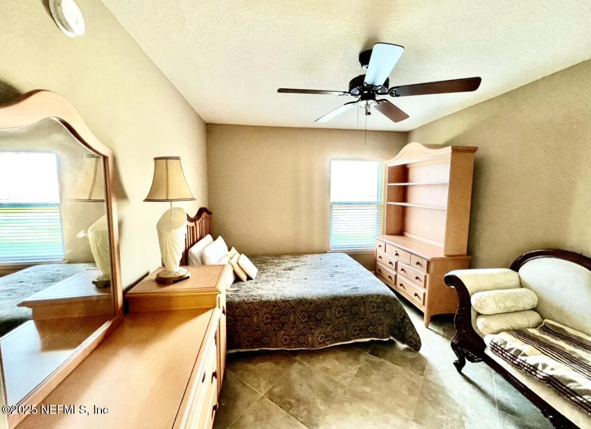 1024 Ardmore Street St. Augustine, FL 32092 - Photo 22 of 25 a bedroom with a bed and a chandelier